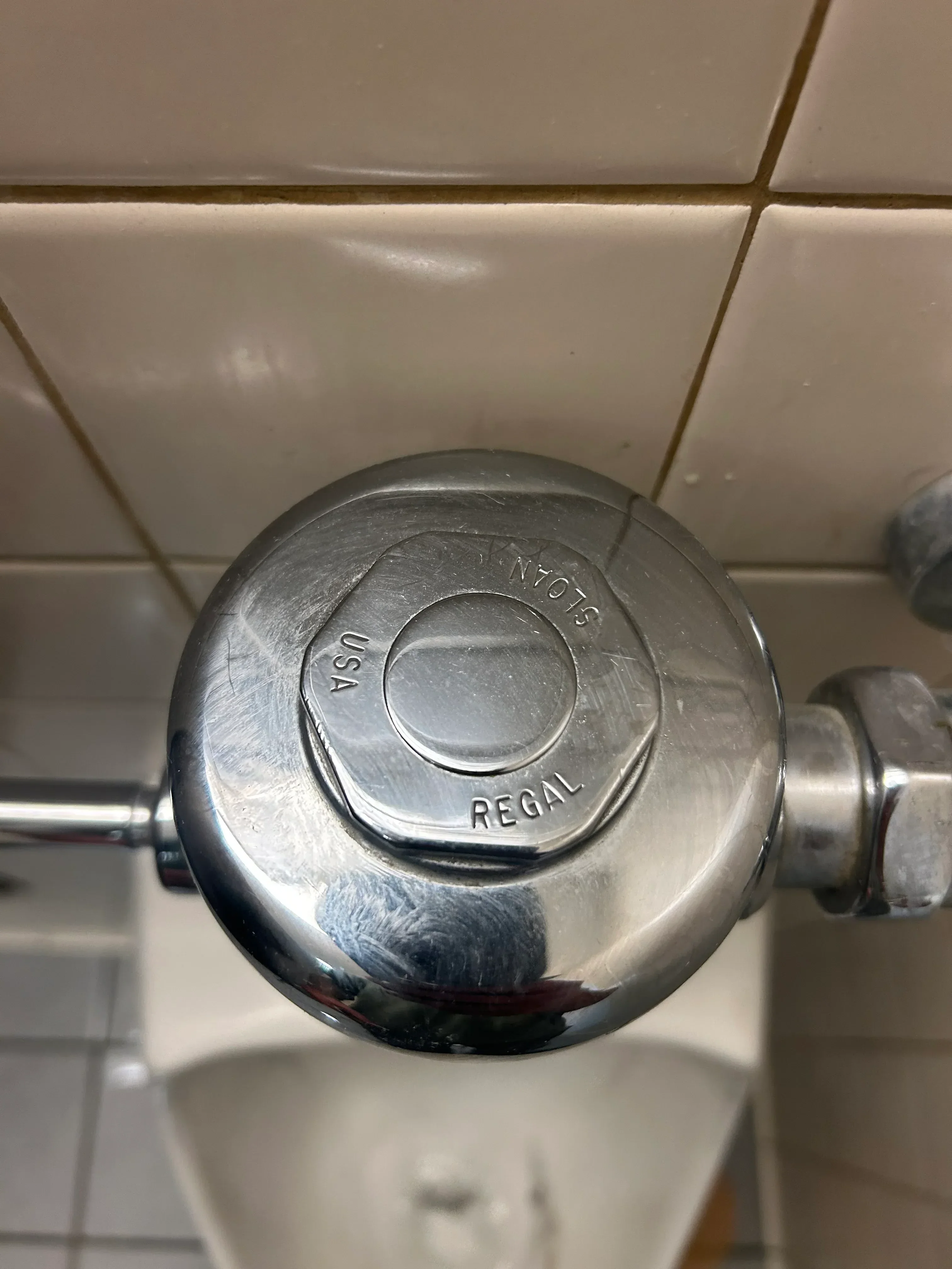 Chrome pressure-balanced shower valve with control handle installed on bathroom wall