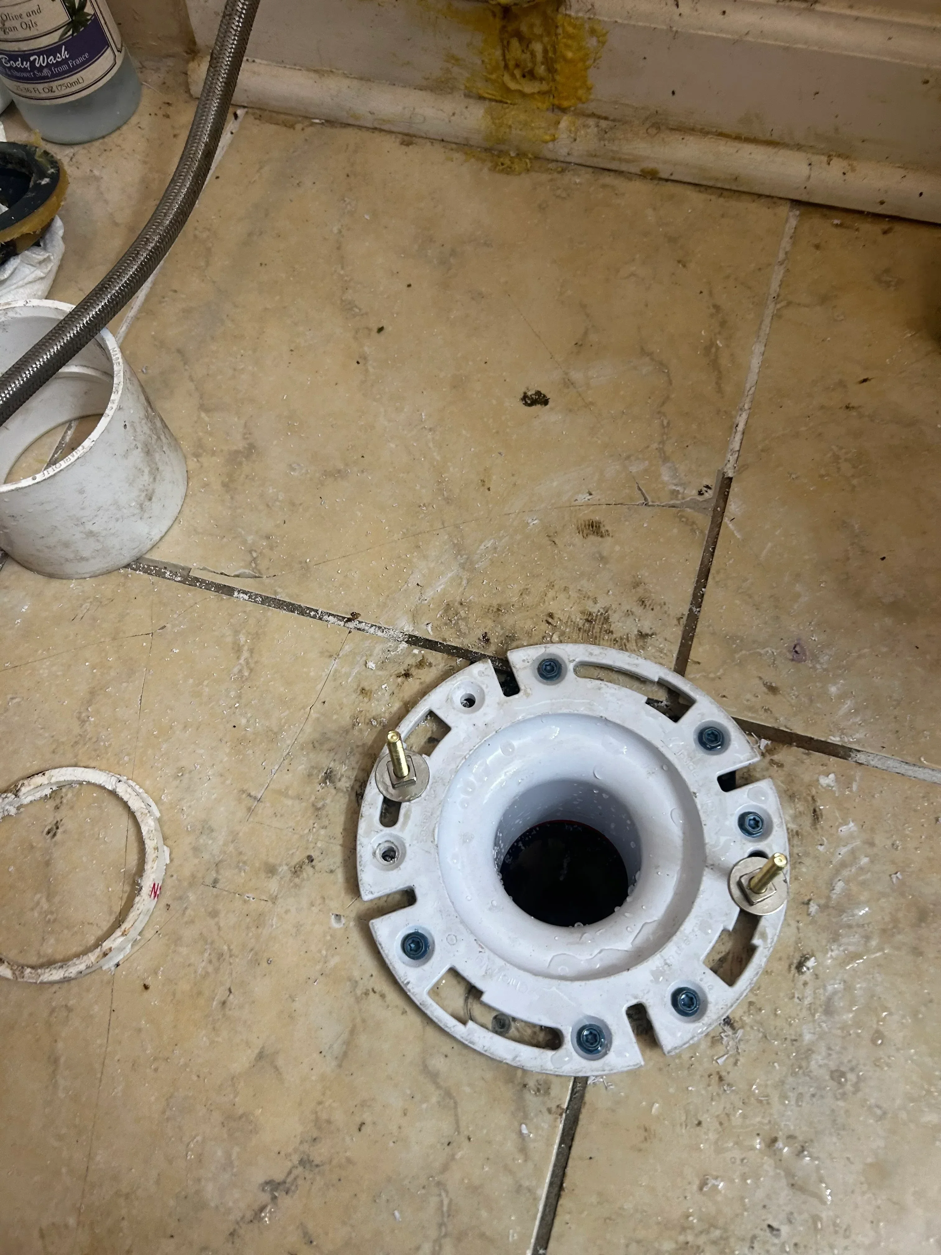 White ceiling electrical box with bolt fasteners and conduit wiring installed on concrete